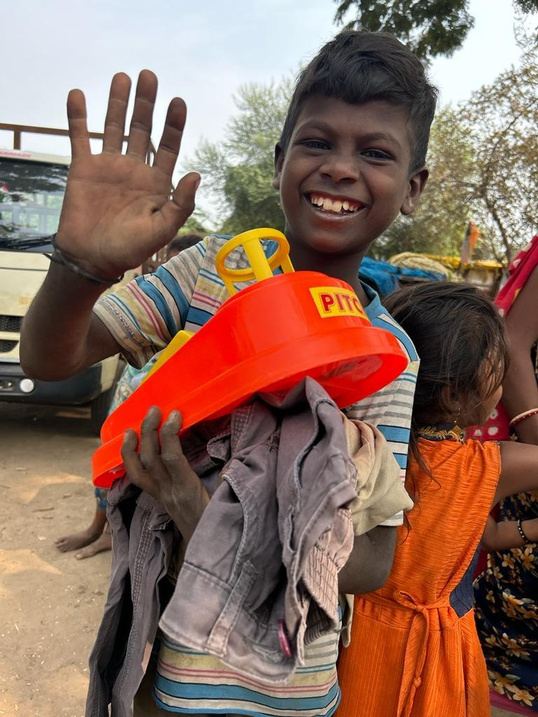 A smiling boy holding a new toy.