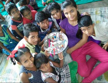 A group of children crowded around a festive plate.