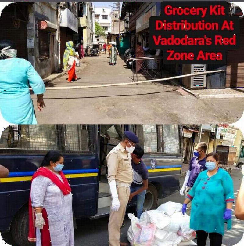 Volunteers in masks and a police officer unloading relief supplies.