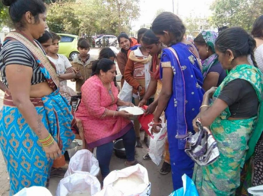 Women from the community collecting supplies at a distribution drive.