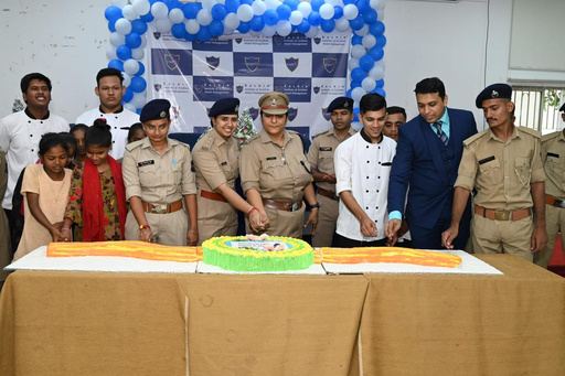 Officers, guests and children gathered around a cake.
